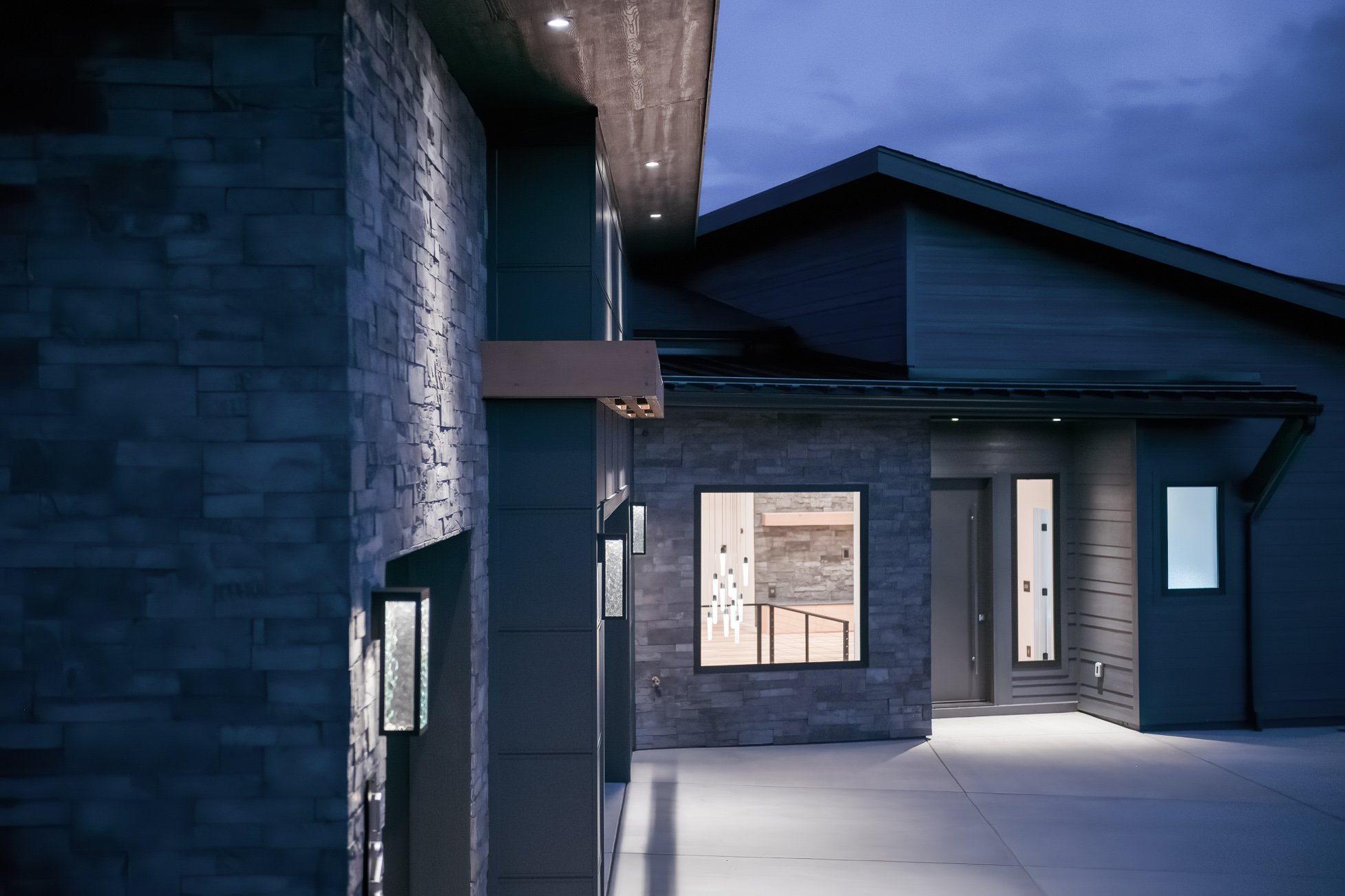 Home exterior at night, medium view